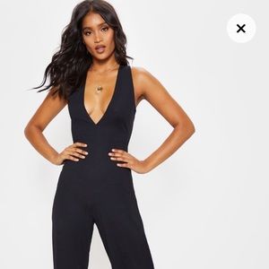 black ribbed jump suit from prettylittlething
